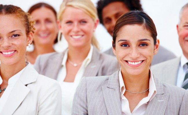 Portrait of happy business people against white