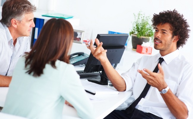 A business consultant discussing with other colleagues